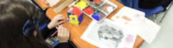 A young artist working at crafting a small house